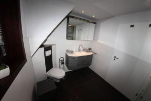 a small bathroom with a sink and a toilet at Haus Trude in Olsberg