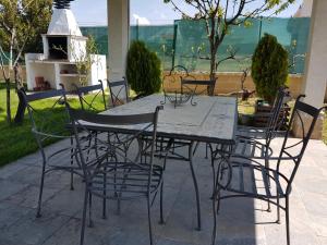 una mesa y sillas en un patio en Tres Hermanos CON PISCINA PRIVADA, en Pelabravo