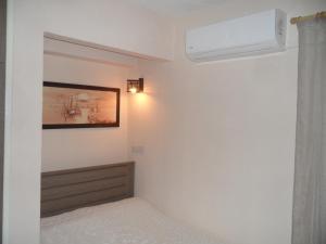 a bedroom with a bed and a air conditioner on the wall at SUNSHINE APTS, TWO BEDROOM , FREE INTERNET, No 3 in Ayia Napa
