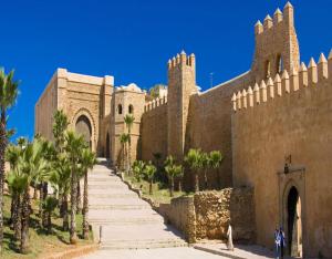 a building with palm trees in front of it at Riad Dar El Mesk in Rabat