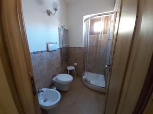 a bathroom with a toilet a sink and a shower at Agriturismo Passo dei Briganti in Agrigento