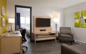 a living room filled with furniture and a tv at Holiday Inn Express Quebec City-Sainte Foy, an IHG Hotel in Quebec City