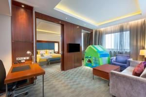 a hotel room with a living room with a living room at Holiday Inn Shanghai Pudong, an IHG Hotel in Shanghai