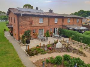 a large brick house with a garden in front of it at Ferienwohnung Feldstein in Hohenkirchen