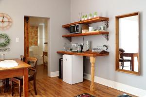 a kitchen with a counter and a table with a microwave at The Fancy Cactus in Colesberg