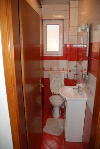 a bathroom with a toilet and a sink at Vila Ratković in Banja Luka
