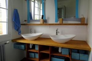 two sinks on a wooden counter in a bathroom at Maison individuelle Côte Basque ( Ciboure ) in Ciboure +19 photos