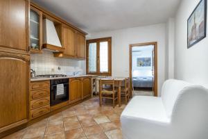 a kitchen with a couch and a table in it at Fiume & Zannoni Apartments by 360Rentals in Florence