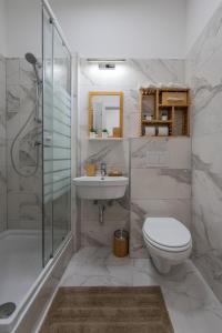 a bathroom with a toilet and a sink and a shower at Radiant Premium Apartments - Fünfhaus in Vienna +71 photos