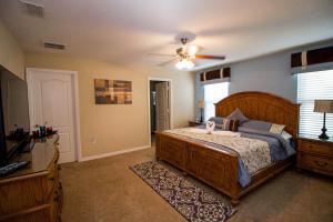 a bedroom with a bed and a ceiling fan at Tuscany at Westside Luxury 5 Bed, 4 Bath Villa near Disney in Kissimmee +45 photos