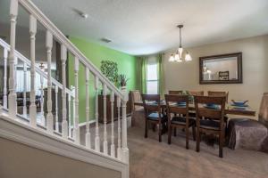 a dining room and living room with a table and chairs at Tuscany at Westside Luxury 5 Bed, 4 Bath Villa near Disney in Kissimmee