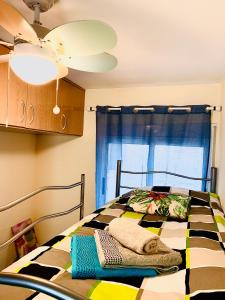 a bedroom with a bed with towels on it at Very best flat ust 800m Postiguet-Beach in Alicante