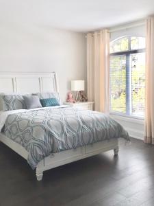 a bedroom with a bed and a window at Comfortable private space in Pickering