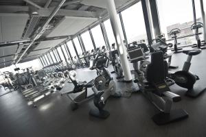 a gym with several treadmills and cardio machines at Stylish - Modern - Serviced Accommodation - In The Heart of Northumberland in Ashington
