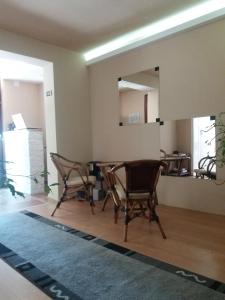 a living room with chairs and a mirror at Hostel Day Off in Aleksinac