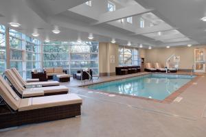a swimming pool with lounge chairs and a waiting room at Holiday Inn Windsor - Wine Country, an IHG Hotel in Windsor