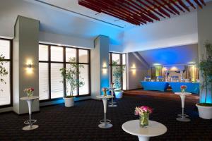 a waiting room with tables and flowers on them at Crowne Plaza Santo Domingo, an IHG Hotel in Santo Domingo