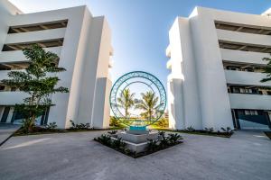 a large white building with a ferris wheel in the middle at Oceana Resort & Conventions in Monterrico