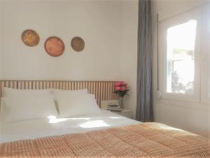 a bedroom with a bed with two plates on the wall at Spitaki Apartments Potos in Potos