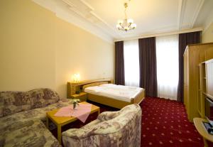 Säng eller sängar i ett rum på Hotel Palacky