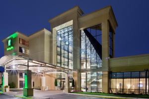 a large building with a lit up facade at night at Holiday Inn Virginia Beach - Norfolk, an IHG Hotel in Virginia Beach