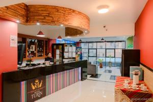 a woman sitting at a counter in a restaurant at Hotel Turin in Tarma