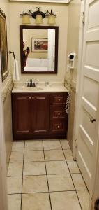 a bathroom with a sink and a mirror at Glen Tavern Inn in Santa Paula