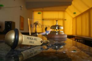 a metal key on a table in a room at Bed And Breakfast Perla Del Sole in Arenella