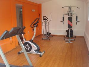 a gym with three exercise bikes and a treadmill at Hotel Centenario in Atlántida
