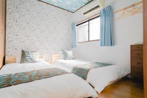 מיטה או מיטות בחדר ב-遊泊昭和町YupaStay