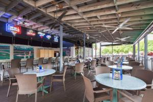 a dining room with tables and chairs in a baseball stadium at Doubletree by Hilton Fort Myers at Bell Tower Shops in Fort Myers