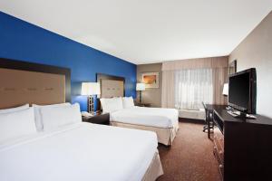 a hotel room with two beds and a flat screen tv at Holiday Inn Seattle DWTN Lake Union by IHG in Seattle +24 photos