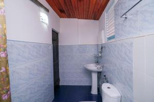 a small bathroom with a sink and a toilet at Sea view Beach Resort in Unawatuna