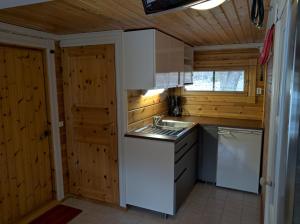 a small kitchen with a sink and a stove at Päiväkulma in Naantali +10 photos