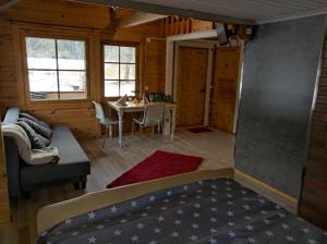 a living room with a table and a couch at Päiväkulma in Naantali