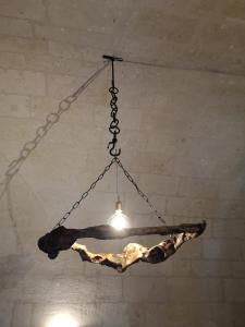
a hanging rope hanging from a ceiling in a room at Sassi e Virtù in Matera
