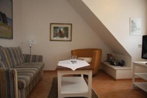 a living room with a couch and a table at Sylter-Appartement in Wenningstedt