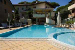 a large swimming pool in front of a building at Residence La Rotonda in Cervia +10 photos