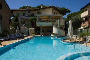 a swimming pool in front of a building at Residence La Rotonda in Cervia