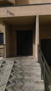 a garage with a black door and some stairs at SavTim Apartaments in Mogilev