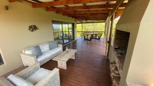 a living room with a couch and a fireplace at Maitlands Cottage in Port Elizabeth