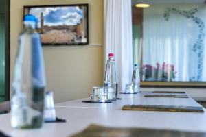 a table with a mirror and a cup on it at Hotel Castello in Sovicille
