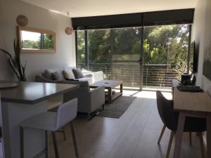 a living room with a couch and a table at The Moonah Apartment 29 in Fingal