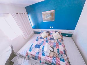 Flat Apart Hotel Marinas Tamandaré في تامانداري: غرفة نوم عليها سرير ولحاف