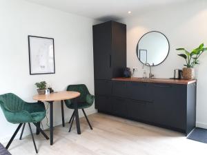 a bathroom with a sink and a table and a mirror at Studio Smidt in Den Burg