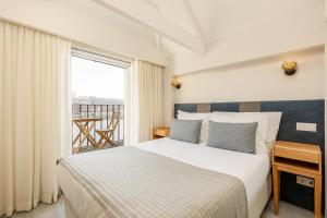 una habitación de hotel con una cama y un balcón en YOUROPO - Ribeira Porto, en Oporto