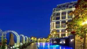 a building with a swimming pool in front of a building at La Mer Penthouse in Varna City