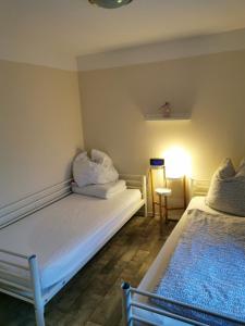 מיטה או מיטות בחדר ב-Ferienhaus Albers