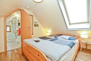 a bedroom with a large bed with a skylight at Ferienzeit in Zingst +29 photos