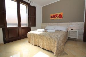a bedroom with a bed with two pillows on it at Appartamento Caradonna in San Vito lo Capo